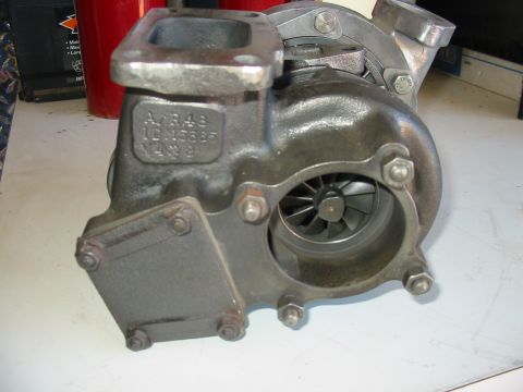 1993 Ford Taurus - Close-up of a turbocharger, showing casting marks and the turbine wheel.