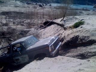 1978 Ford Bronco - This 1978 Ford Bronco is navigating a challenging off-road terrain near a body of water.