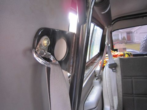 1996 Ford Bronco - Interior view of a vehicle's roll cage mount and seatbelt, with a Supermotors logo in the corner.