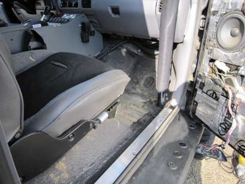 1996 Ford Bronco - Interior view of a 1996 Ford Bronco, highlighting the driver's seat and the disassembled door panel.