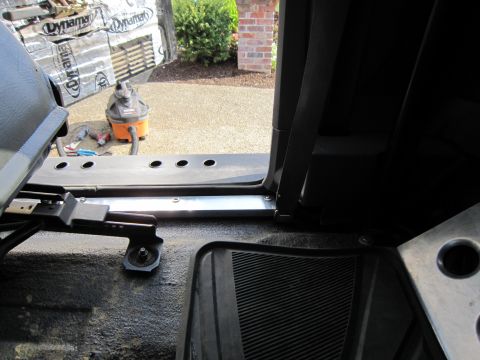 1996 Ford Bronco - Work is being done on the interior of a vehicle, with tools and a shop vac visible outside.