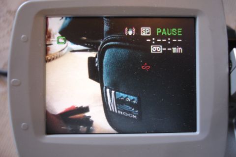 1993 Ford Taurus - The camcorder screen shows it is in pause mode with a tape counter and a bag with a logo.