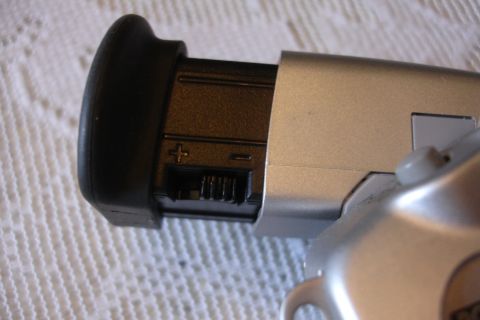 1993 Ford Taurus - Close-up view of a camera's battery compartment, showing the positive and negative terminals.