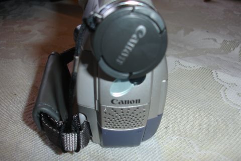 1993 Ford Taurus - Close-up of a Canon camcorder, the brand name and lens cap.