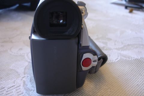 1993 Ford Taurus - Close-up view of a camcorder's battery pack and recording controls, with a viewfinder visible at the top.