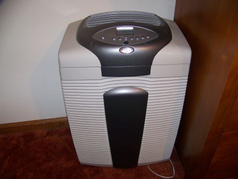 2001 Dodge 1500 - An air purifier with a digital display and control panel is shown in a room with carpet and wood paneling.