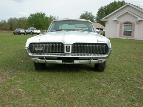 1968 Mercury Cougar - A 1968 Mercury Cougar is shown from the front, highlighting its distinctive grille and classic styling.