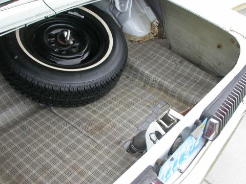1968 Mercury Cougar - The trunk of a 1968 Mercury Cougar shows its plaid lining and a spare tire.
