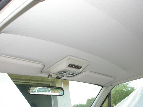 1968 Mercury Cougar - Interior shot showing the headliner and overhead console, with a pickup truck reflected in the rearview mirror.