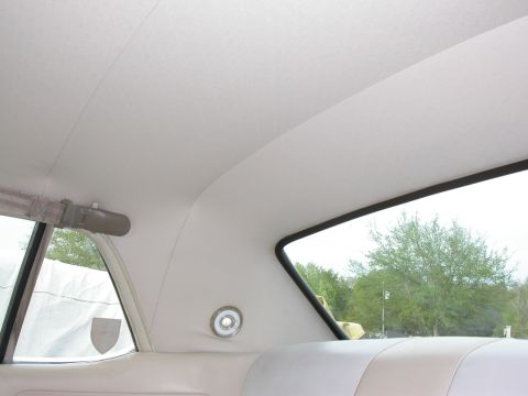 1968 Mercury Cougar - View from inside a car, looking out the rear window at trees and sky.