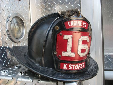1992 Ford F-150 - A firefighter helmet with "ENGINE CO 16 K STOKES" is placed on a textured metal surface.