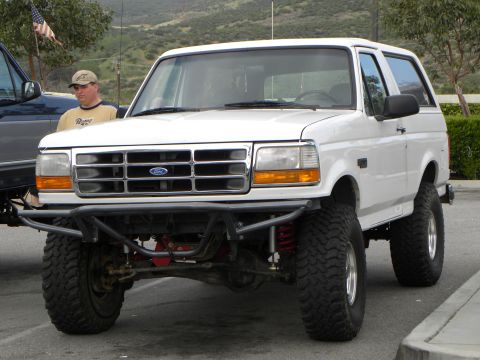 1995 Ford Bronco - White 1995 Ford Bronco modified with a custom front bumper and lifted suspension.