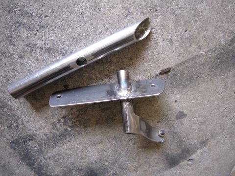 1996 Ford Bronco - Two metal parts, possibly for a vehicle, are shown on a concrete floor. A website watermark is visible in the lower right corner.
