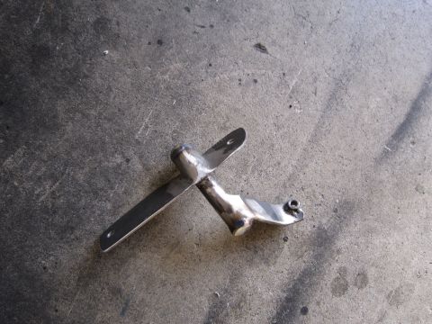 1996 Ford Bronco - A polished chrome mirror bracket is shown against a concrete background.