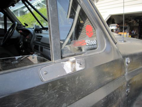 1996 Ford Bronco - 1996 Ford Bronco interior and side panel detail, a 'Blood Enterprises' sticker on the rear quarter window.