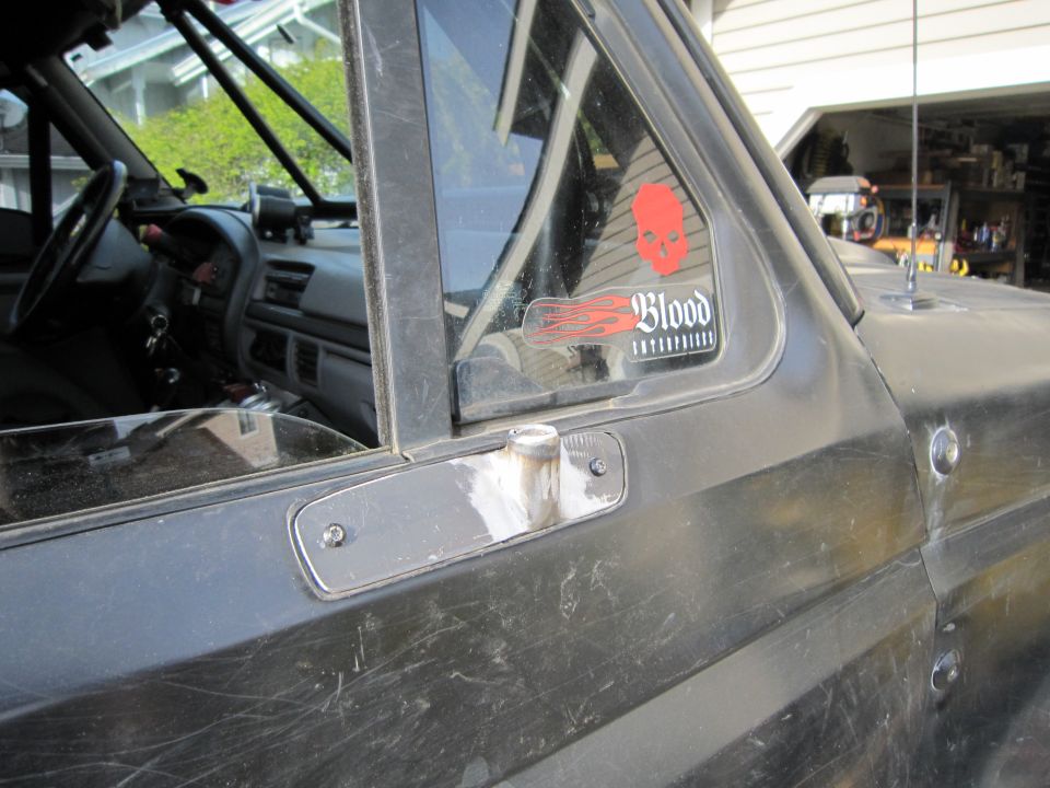 Interior view of a 1996 Ford Bronco showing dashboard and door panel, with a 'Blood Enterprises' sticker on the window