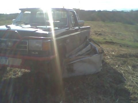 1995 Ford F-150 - This Ford F-150 shows significant damage to its front passenger side fender and wheel well area.