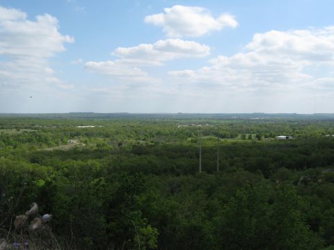 Wide landscape view with trees and sky, Supermotors logo visible