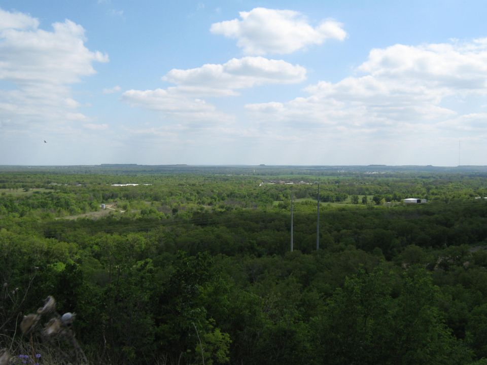 Wide landscape view with trees and sky, Supermotors logo visible