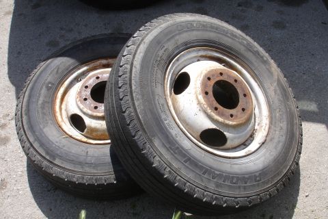 1993 Ford Taurus - A pair of tires and rims are shown resting on a concrete surface.