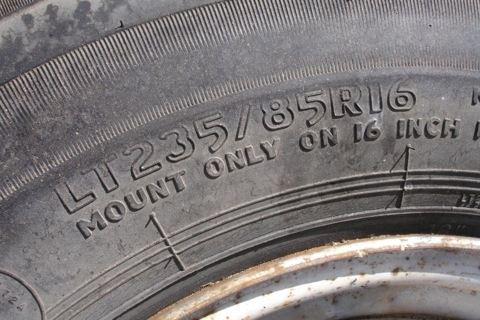 Tire sidewall showing LT235/85R16 and 'MOUNT ONLY ON 16 INCH' text