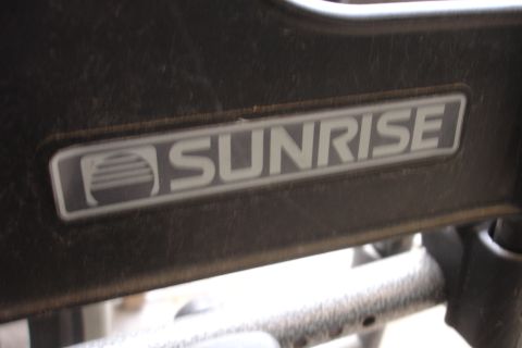 1993 Ford Taurus - Close-up of a Sunrise logo emblem.