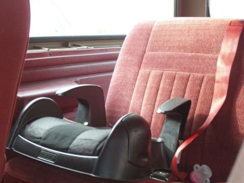 1988 Ford Bronco - Interior view of a vehicle seat with a child car seat base installed.