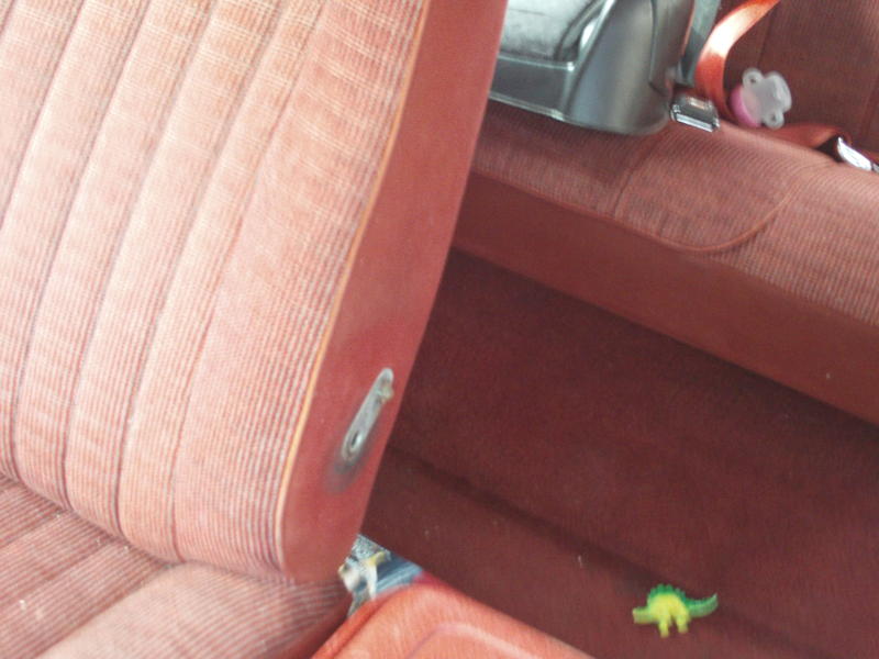 Red striped interior seats with seatbelt buckle