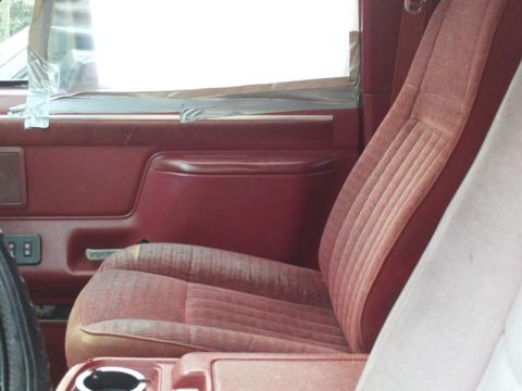 1988 Ford Bronco - Interior view of a vehicle's maroon cloth seat and door panel, with a watermark visible.