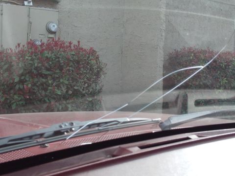 1988 Ford Bronco - Windshield wipers and a cracked windshield are visible from the interior of the vehicle.