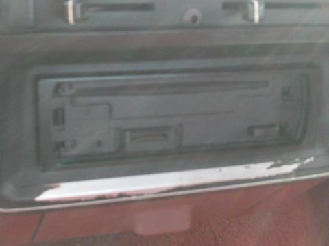 1988 Ford Bronco - Close-up of an aftermarket car stereo unit, likely from the late 80s or early 90s.