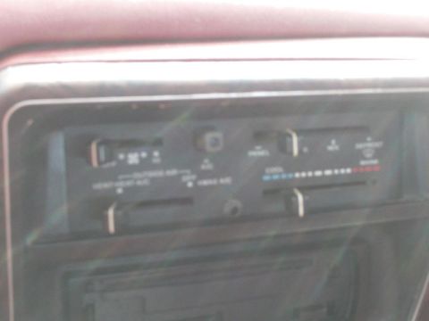 1988 Ford Bronco - The climate control panel shows temperature and fan speed settings, along with air direction options.
