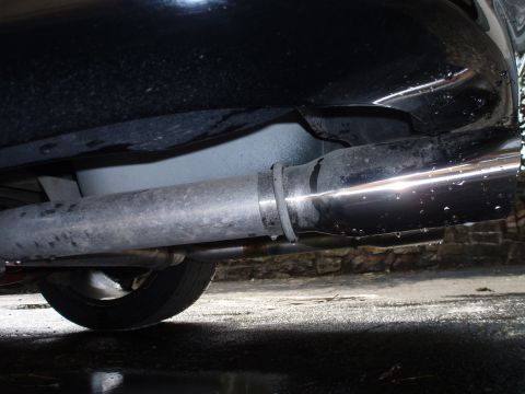 2002 Chevrolet Camaro - Underside view of a vehicle's exhaust system, showing the pipe and a tire.