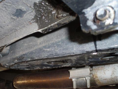 2002 Chevrolet Camaro - Underside view of a vehicle's exhaust system showing a clamp and a fluid leak.