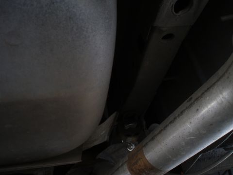 2002 Chevrolet Camaro - Underside view of a vehicle's exhaust system, a large muffler and metal piping.