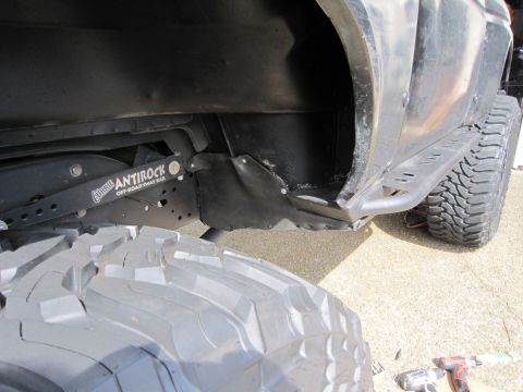 1996 Ford Bronco - Close-up view of off-road suspension components and a large tire.
