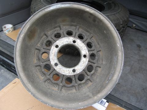 1986 Ford Bronco - A single aluminum wheel is shown, likely for a truck or SUV, with a tire visible in the background.