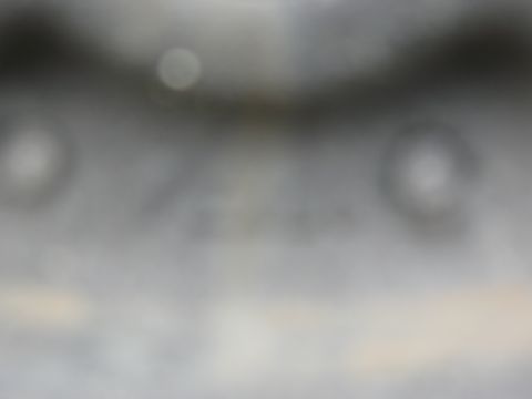 1986 Ford Bronco - A close-up, out-of-focus view of a vehicle component with visible text.