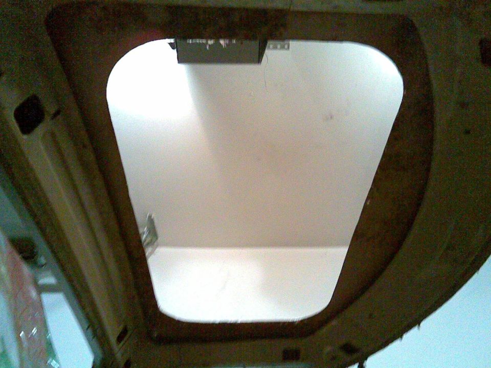 view looking up at an open roof section of a vehicle interior