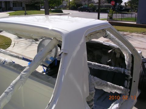 1972 Ford Ranchero - A white 1972 Ford Ranchero is undergoing restoration, with its interior and roof covered in protective materials.