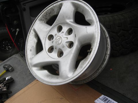 1986 Ford Bronco - A single alloy wheel with a Toyota emblem is shown, with a spare tire and vehicle interior visible in the background.