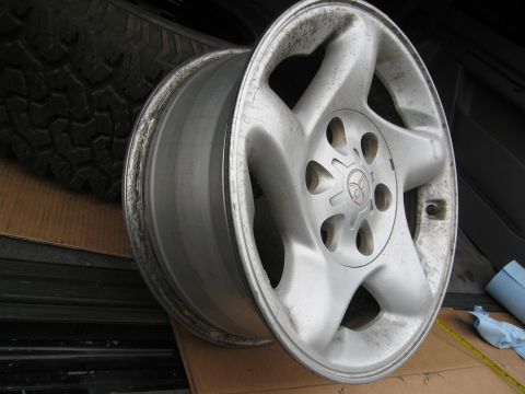 1986 Ford Bronco - This alloy wheel features a prominent Toyota logo and a five-spoke design, likely from a Toyota vehicle.
