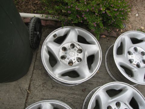 1986 Ford Bronco - These alloy wheels feature a five-spoke design and a central Toyota emblem, indicating they are not from a Ford Bronco.