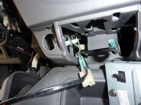 2002 Toyota Sequoia - Close-up view of exposed wiring and a light bulb socket on a vehicle's dashboard.