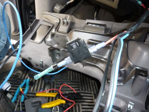 2002 Toyota Sequoia - A close-up view of automotive wiring and a fuse holder within a vehicle's interior.