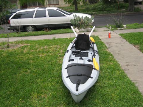 1953 Ford Mainline - Kayak and station wagon parked on a residential street.