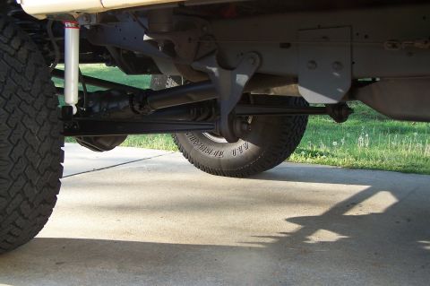 1990 Ford Bronco - Close-up view of the rear axle and suspension system of a vehicle, showing mechanical components.