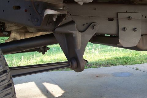 1990 Ford Bronco - Undercarriage view of a vehicle's suspension system, focusing on a specific component.