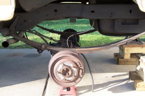 1990 Ford Bronco - Undercarriage view of a vehicle, focusing on suspension and exhaust parts.