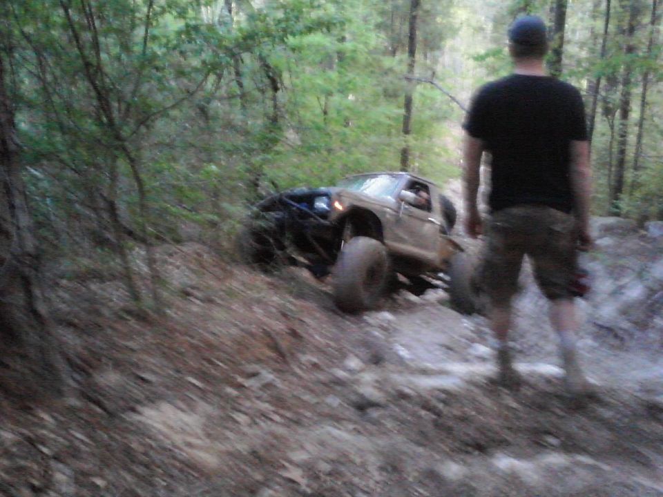 Brown 1984 Ford Bronco II navigating a rocky off-road trail